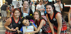 Amanda and Chris with basketball players at the free hugs event at Canelands